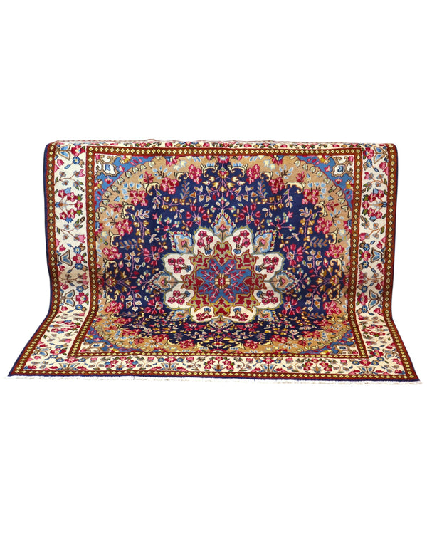 Tappeto Kirman 200x200 cm con motivo floreale centrale in blu, rosso e oro, bordura decorata, annodato a mano con lana pregiata e ordito in cotone.