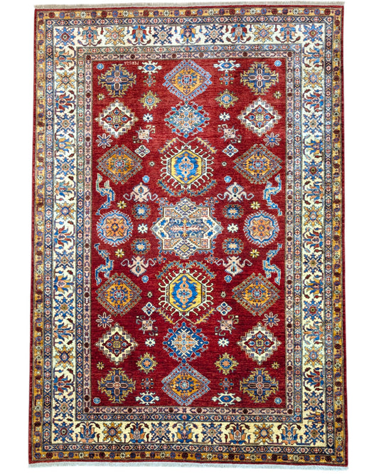 Tappeto Shirvan 300x208 cm con fondo rosso, motivi geometrici blu, gialli e avorio, tramato ed annodato a mano, provenienza Caucaso.