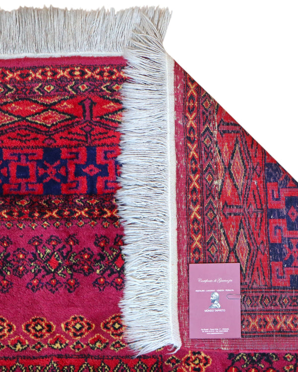 Tappeto Turkemen 278x185 cm con motivo geometrico ricco di rosa, blu e giallo, annodato a mano con lana di alta qualità e ordito in cotone resistente.