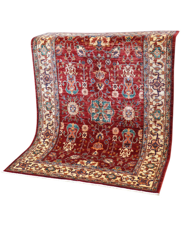 Tappeto Farahan 176x127 cm con motivi floreali e geometrici in rosso, blu, verde e oro su fondo beige.