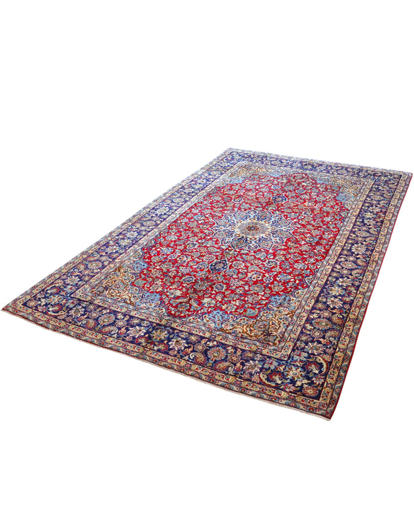 Tappeto persiano Najafabad 500x400 cm, fondo rosso con ampio medaglione centrale blu e cornice floreale scura, annodato a mano in lana vegetale.