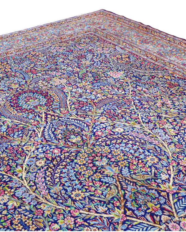 Tappeto Tabriz persiano 486x357 cm rettangolare, annodato a mano, con motivo floreale fitto multicolore su fondo azzurro e blu.