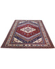 Tappeto Shirvan 274x184 cm con fondo rosso, medaglione centrale blu e avorio e bordure geometriche multicolori, tramato ed annodato a mano.