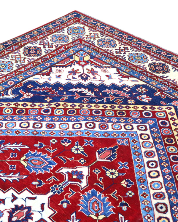 Tappeto Shirvan 274x184 cm con fondo rosso, medaglione centrale blu e avorio e bordure geometriche multicolori, tramato ed annodato a mano.
