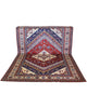 Tappeto Shirvan 274x184 cm con fondo rosso, medaglione centrale blu e avorio e bordure geometriche multicolori, tramato ed annodato a mano.