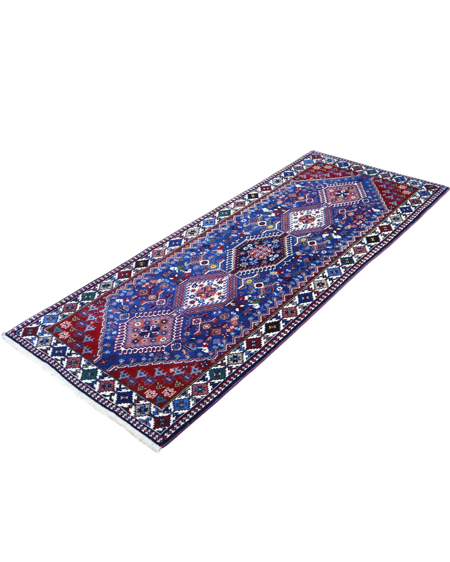 Tappeto persiano Yalameh 204x82 cm, corridore con fondo blu intenso e motivi geometrici rossi, avorio e verdi, annodato a mano in lana vegetale.