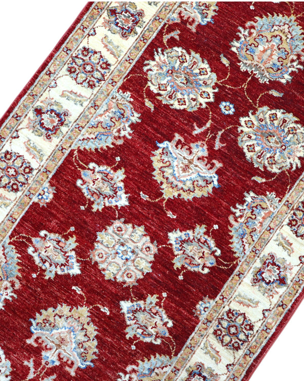 Tappeto Ziegler Afghan 199x83 cm annodato a mano, fondo rosso intenso con decorazioni floreali avorio e cornice chiara.