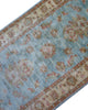 Tappeto Ziegler 257x77 cm, provenienza Afghanistan, fondo azzurro con motivi floreali beige e rosso mattone, corridore annodato a mano in lana vegetale.