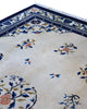 Tappeto Pechino 275x189 cm con fondo avorio, motivi floreali blu e arancio e cornice geometrica, tramato ed annodato a mano, provenienza Cina.