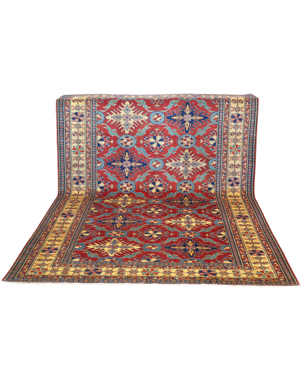 Tappeto Shirvan 289x196 cm con fondo rosso e motivi geometrici gialli, blu e avorio, tramato ed annodato a mano, provenienza Caucaso.