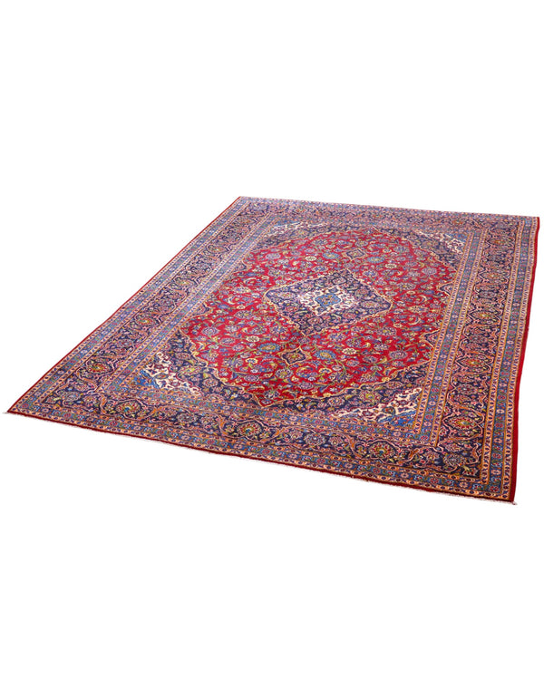 Tappeto persiano Kashan 400x290 cm, fondo rosso con medaglione centrale blu e avorio, cornice scura floreale, annodato a mano in lana vegetale.