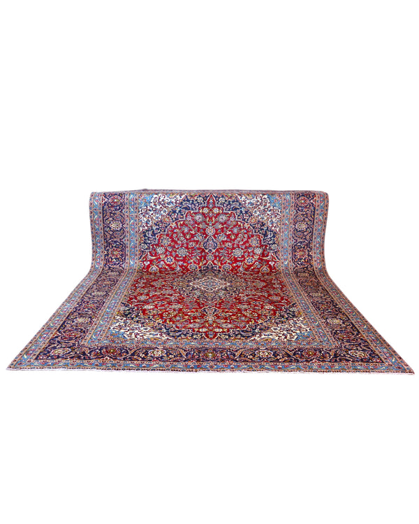 Tappeto persiano Kashan 400x300 cm, fondo rosso con medaglione centrale e cornice floreale, annodato a mano in lana vegetale.