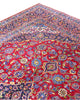 Tappeto persiano Kashan 400x290 cm, fondo rosso con medaglione centrale blu e avorio, cornice scura floreale, annodato a mano in lana vegetale.