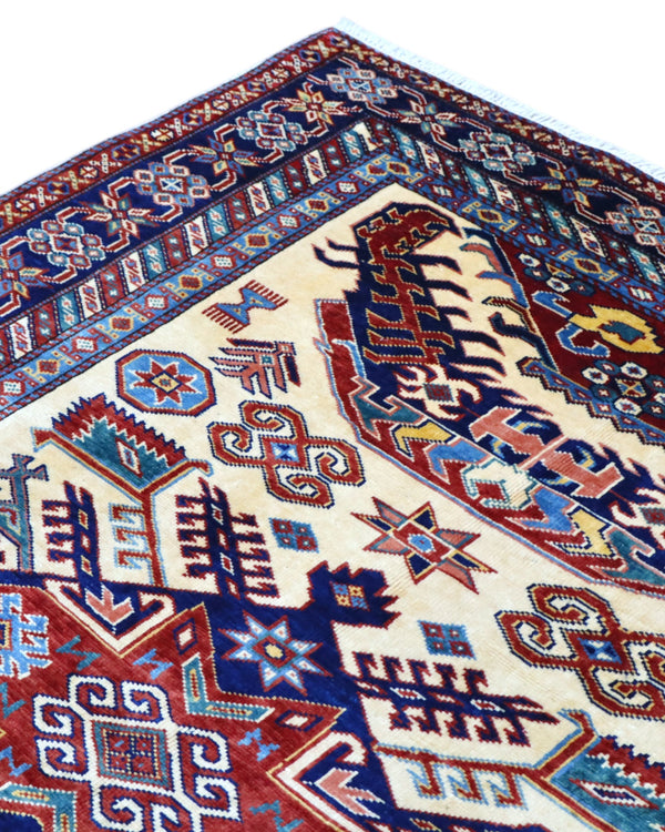 Tappeto Shirvan Afghan 157x121 cm con fondo avorio, motivi geometrici blu e rossi, tramato ed annodato a mano, provenienza Afghanistan.