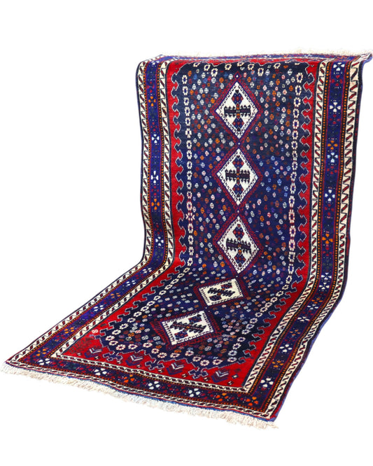 Tappeto Balucestan 215x100 cm annodato a mano, con sequenza di rombi centrali su fondo blu notte e bordi rosso granata.