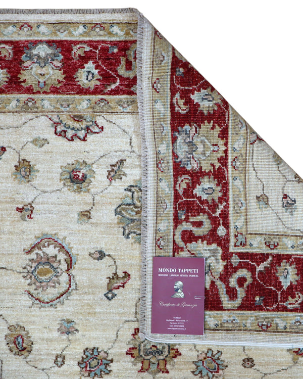 Tappeto Ziegler 175x127 cm, annodato a mano, fondo avorio con motivi floreali stilizzati e cornice rosso rubino.