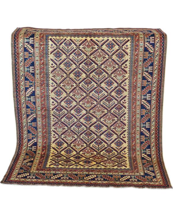 Tappeto Shirvan 166x120 cm in lana annodata a mano, fondo chiaro con rombi geometrici e cornici caucasiche.