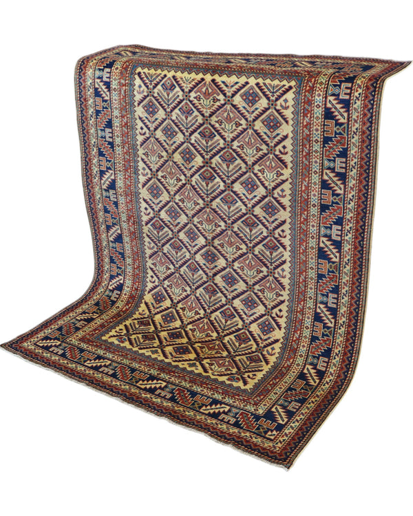 Tappeto Shirvan 166x120 cm in lana annodata a mano, fondo chiaro con rombi geometrici e cornici caucasiche.