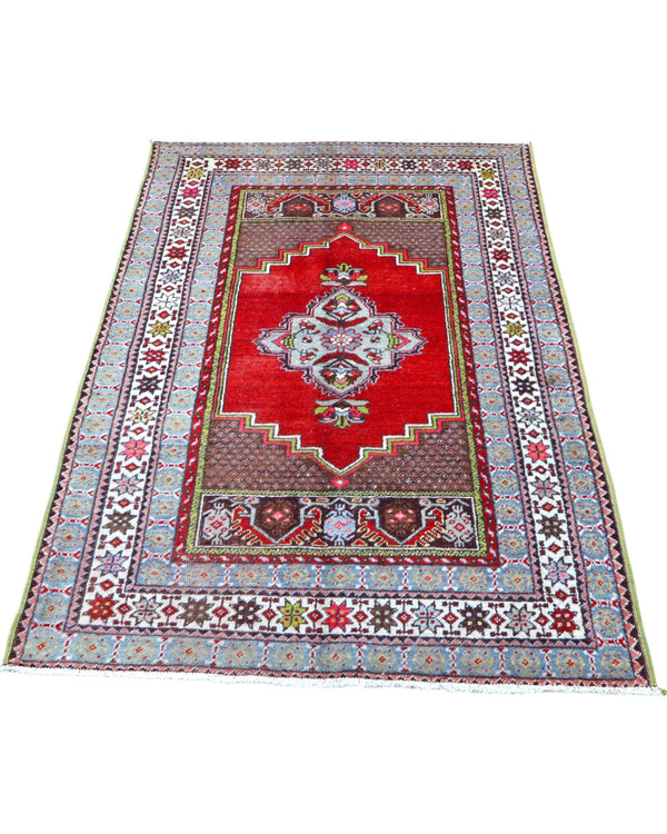 Tappeto Turco 170x108 cm annodato a mano, con campo rosso, medaglione bianco centrale e bordo riccamente decorato.