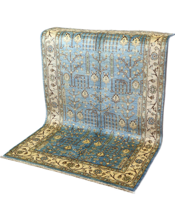 Tappeto Ziegler 188x123 cm con disegno floreale su fondo azzurro e bordura beige, perfetto per arredamenti eleganti e moderni.