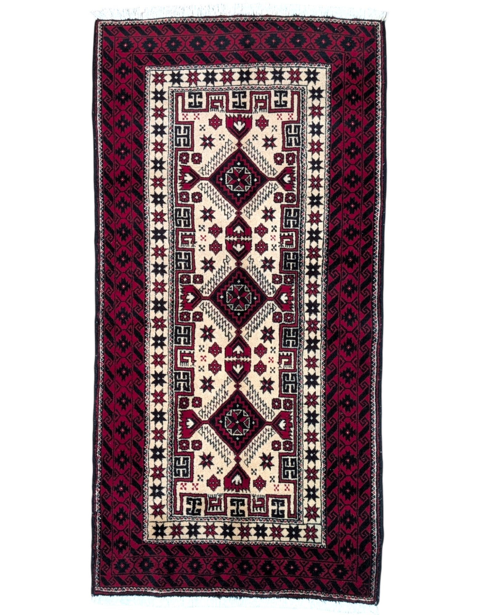 Tappeto Balochistan 187x95 cm annodato a mano, fondo avorio con motivi geometrici rossi, neri e verdi.