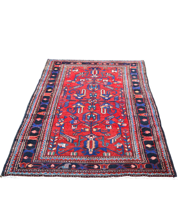 Tappeto Hamedan 200x130 cm persiano, rettangolare, annodato a mano, fondo rosso con motivi geometrici e floreali blu e avorio, bordi decorati.