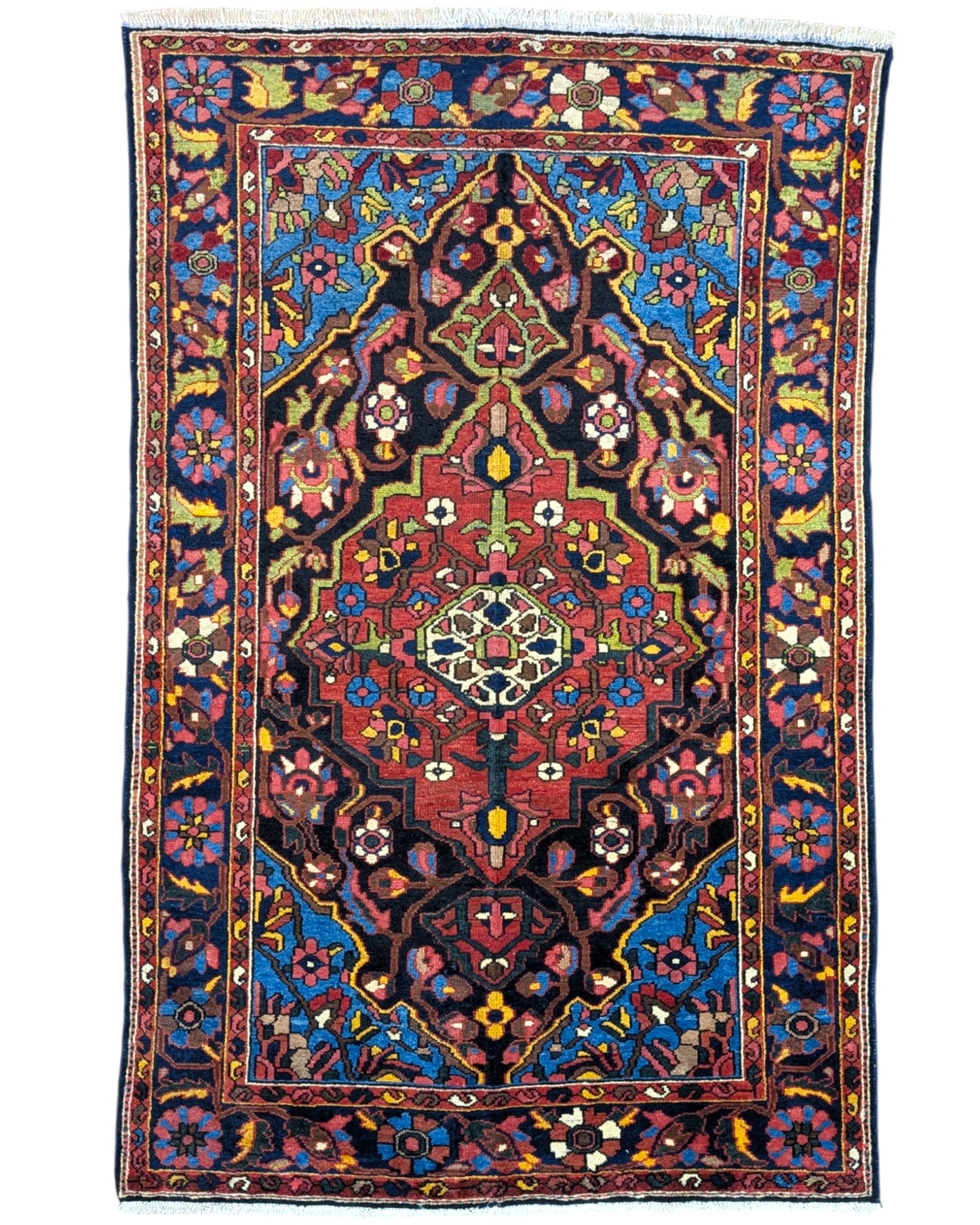 Tappeto Nahavand "Giardino Persiano" blu con motivi floreali e geometrici, annodato a mano in Persia con lana e cotone tinti con colori vegetali.
