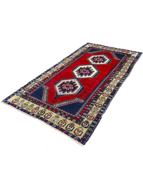 Tappeto Turko 273x149 cm annodato a mano, rettangolare, fondo rosso intenso con tre medaglioni geometrici blu e avorio, cornice decorata con motivi anatolici.