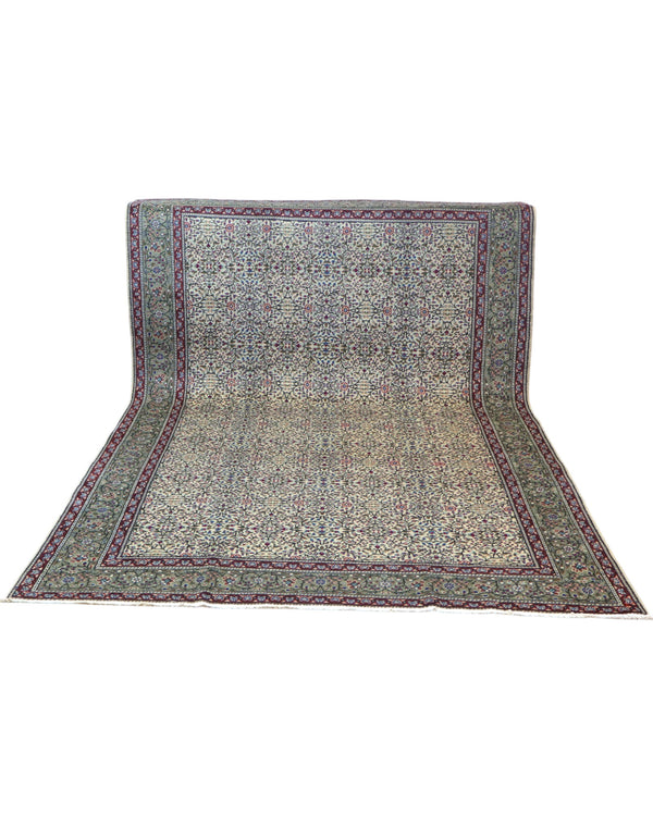 Tappeto Ushak turco 296x198 cm con fondo chiaro e motivi floreali e geometrici in rosa, blu e verde, tramato ed annodato a mano, provenienza Turchia.