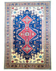 Tappeto Shirvan 317x224 cm con fondo blu, medaglione rosso e dettagli geometrici avorio e giallo, tramato ed annodato a mano, provenienza Caucaso.