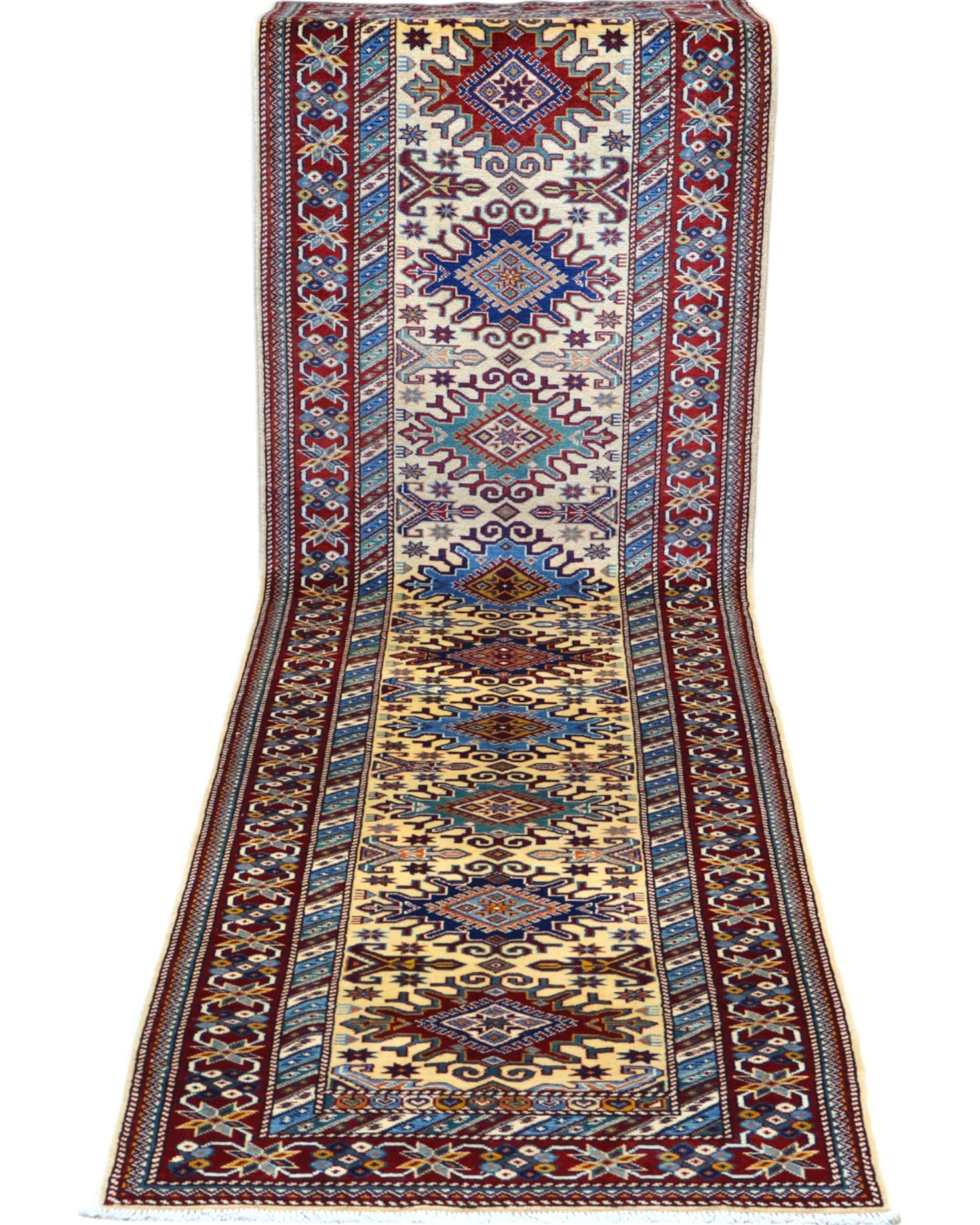 Elegante tappeto Shirvan annodato a mano in pura lana con colori vegetali. Dimensioni 301x83 cm, fondo beige con cornice rossa e motivi geometrici tradizionali afgani. Ideale per corridoi e ambienti raffinati.