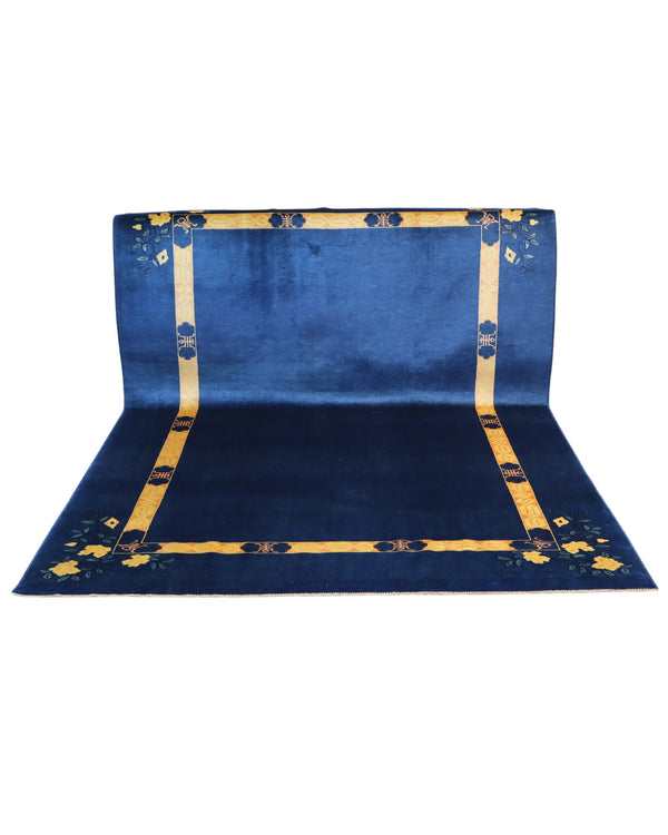 Tappeto moderno 284x213 cm Persia con fondo blu e cornice gialla decorata da fiori stilizzati, annodato a mano in lana naturale.