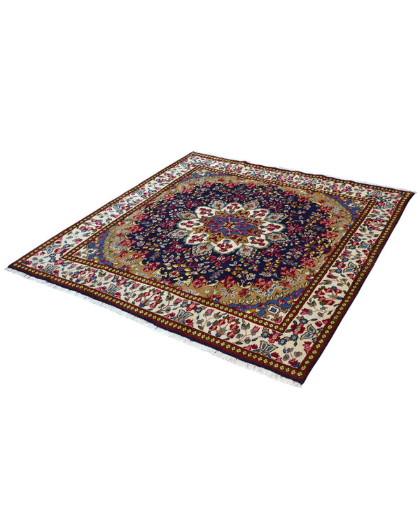 Tappeto Kirman 200x200 cm con motivo floreale centrale in blu, rosso e oro, bordura decorata, annodato a mano con lana pregiata e ordito in cotone.