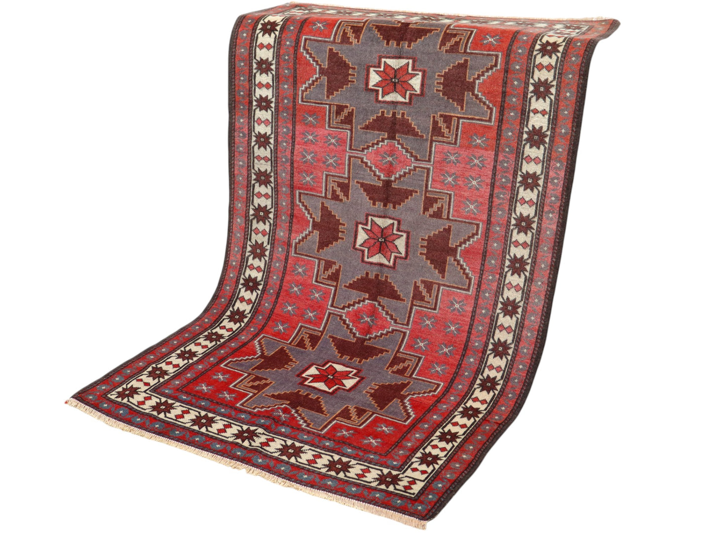 Tappeto Kazak 181x113 cm con motivo geometrico a stelle in rosso, blu e beige, annodato a mano con lana pregiata e ordito in cotone robusto.