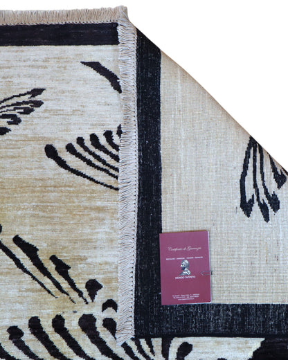 Tappeto moderno 350x250 cm con fondo beige e motivi di uccelli neri stilizzati, annodato a mano.