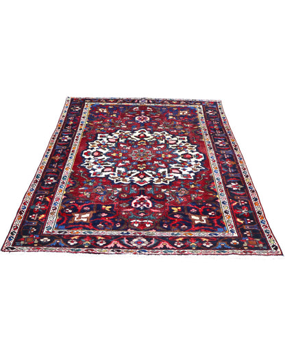 Tappeto Bakhtiyari annodato a mano, 214 x 149 cm, fondo rosso vinaccia con motivi decorativi raffinati.