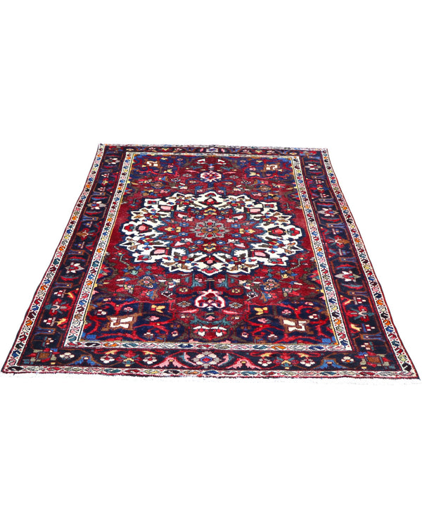 Tappeto Bakhtiyari annodato a mano, 214 x 149 cm, fondo rosso vinaccia con motivi decorativi raffinati.