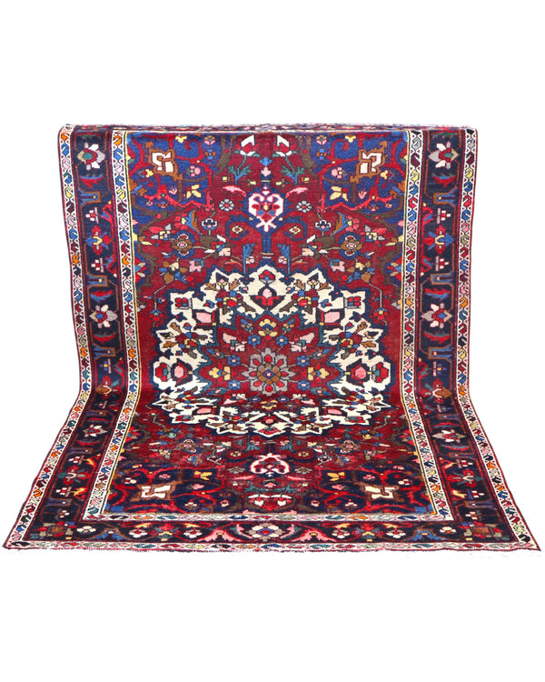 Tappeto Bakhtiyari annodato a mano, 214 x 149 cm, fondo rosso vinaccia con motivi decorativi raffinati.