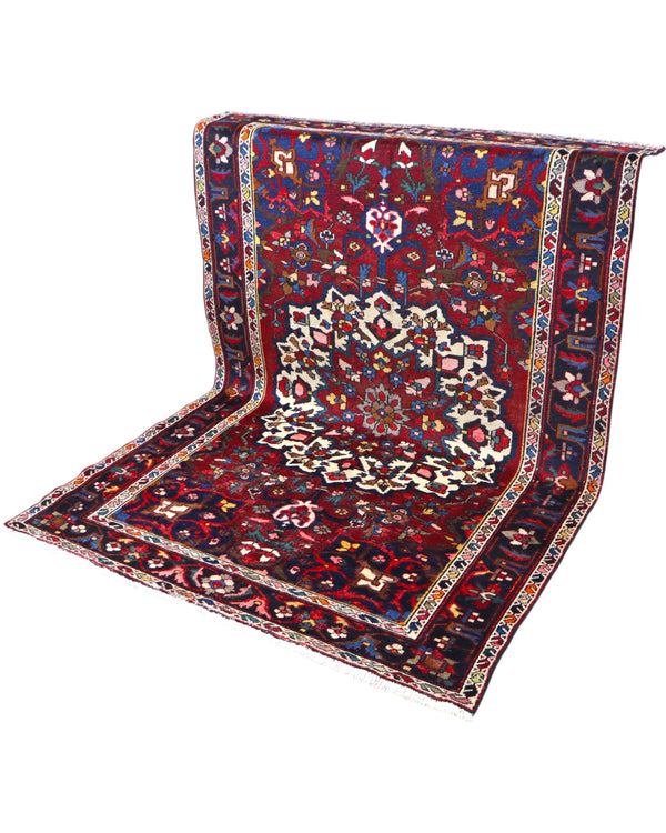 Tappeto Bakhtiyari annodato a mano, 214 x 149 cm, fondo rosso vinaccia con motivi decorativi raffinati.