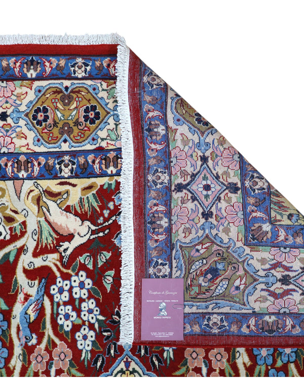 Tappeto Esfahan persiano “Giardino Incantato”, annodato a mano, fondo rosso melograno con alberi, cervi e uccelli, lana tinta vegetale, certificato di autenticità incluso.