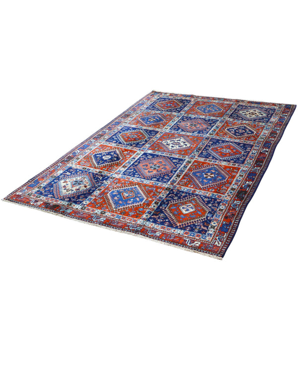 Tappeto Yalamhe persiano, fondo rosso mattone con motivi geometrici in blu, annodato a mano, 232x157 cm.