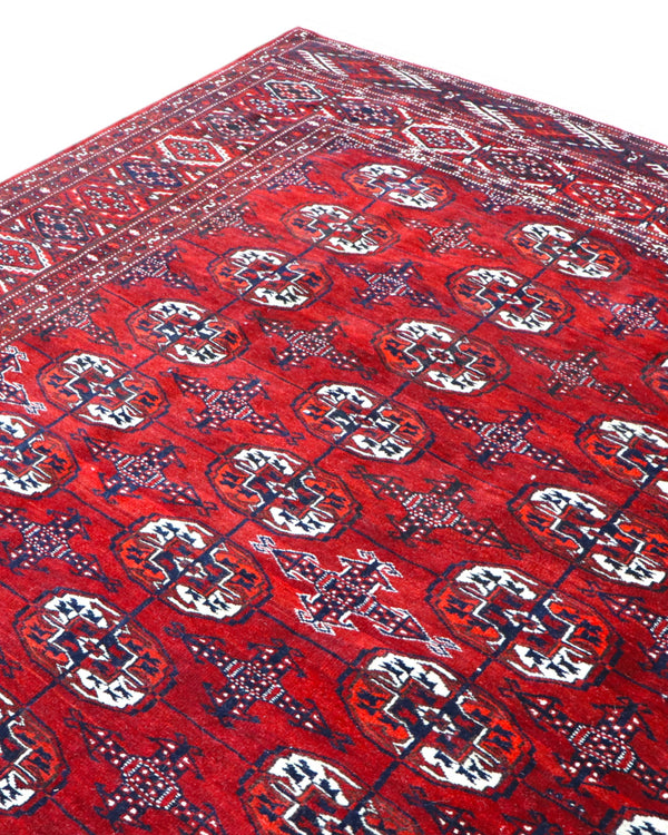 Tappeto Bukhara 324x205 cm con fondo rosso scuro e motivi a gul geometrici in nero, avorio e blu, tramato ed annodato a mano, provenienza Bukhara.