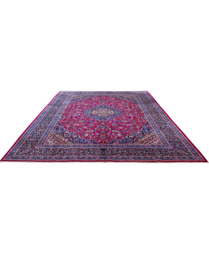 Tappeto persiano Mashhad 408x300 cm, fondo rosso con medaglione centrale e cornice floreale blu e oro, annodato a mano in lana vegetale.