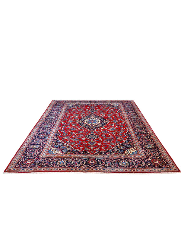 Tappeto persiano Kashan 370x250 cm, fondo rosso con medaglione centrale e cornice blu floreale, annodato a mano in lana vegetale.