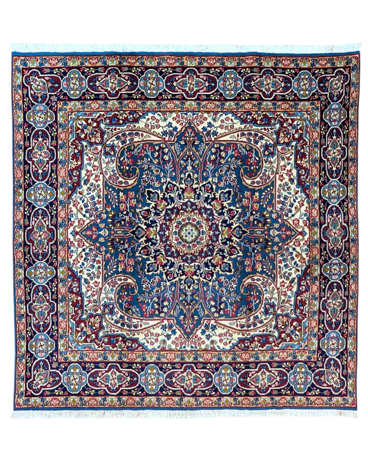 Tappeto Kirman 200x200 cm con motivo floreale centrale in blu, rosso e oro, bordura decorata, annodato a mano con lana pregiata e ordito in cotone.