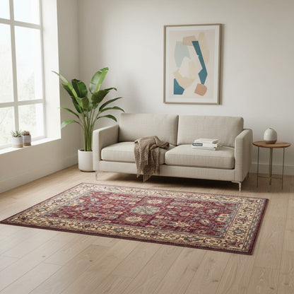 Tappeto Farahan 176x127 cm con motivi floreali e geometrici in rosso, blu, verde e oro su fondo beige.
