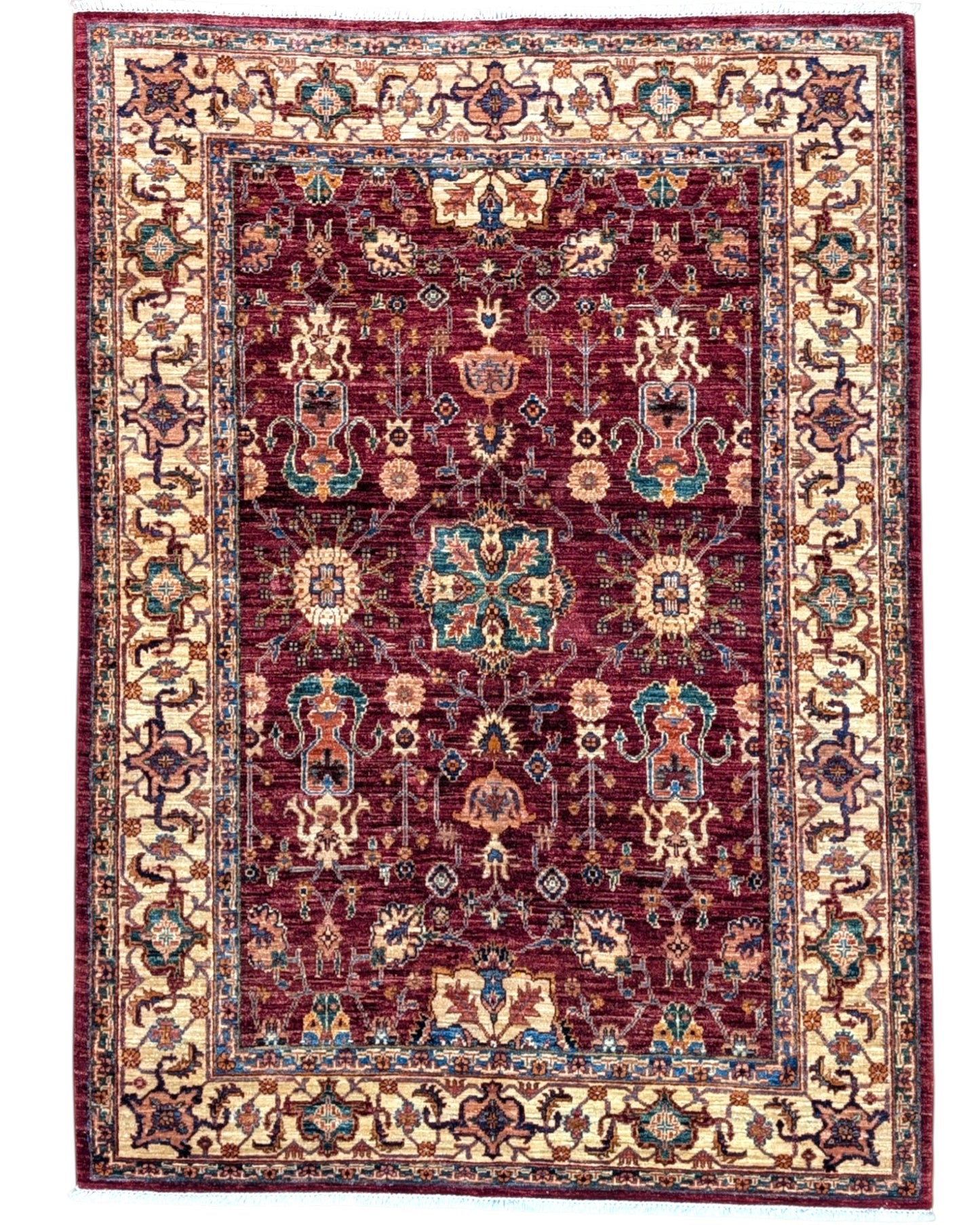 Tappeto Farahan 176x127 cm con motivi floreali e geometrici in rosso, blu, verde e oro su fondo beige.