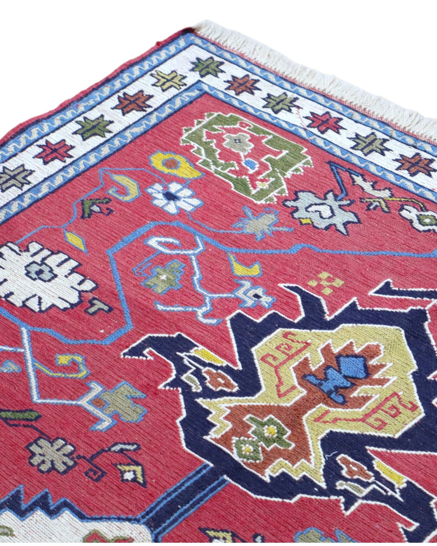 Tappeto Kilim 190x122 cm con motivi geometrici in rosso, blu, giallo e verde su fondo beige.