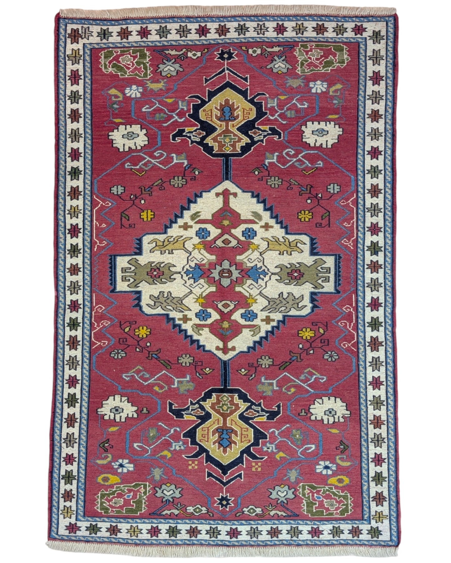 Tappeto Kilim 190x122 cm con motivi geometrici in rosso, blu, giallo e verde su fondo beige.