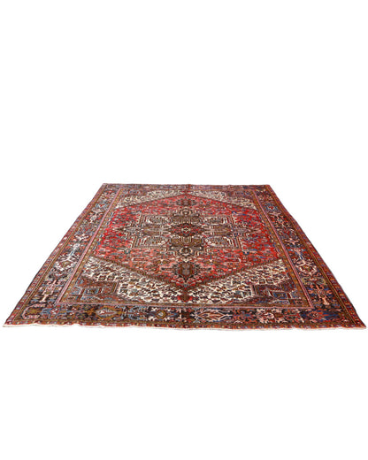 Tappeto Heriz persiano 347x255 cm, annodato a mano in lana e cotone, con medaglione geometrico e motivi floreali tradizionali.